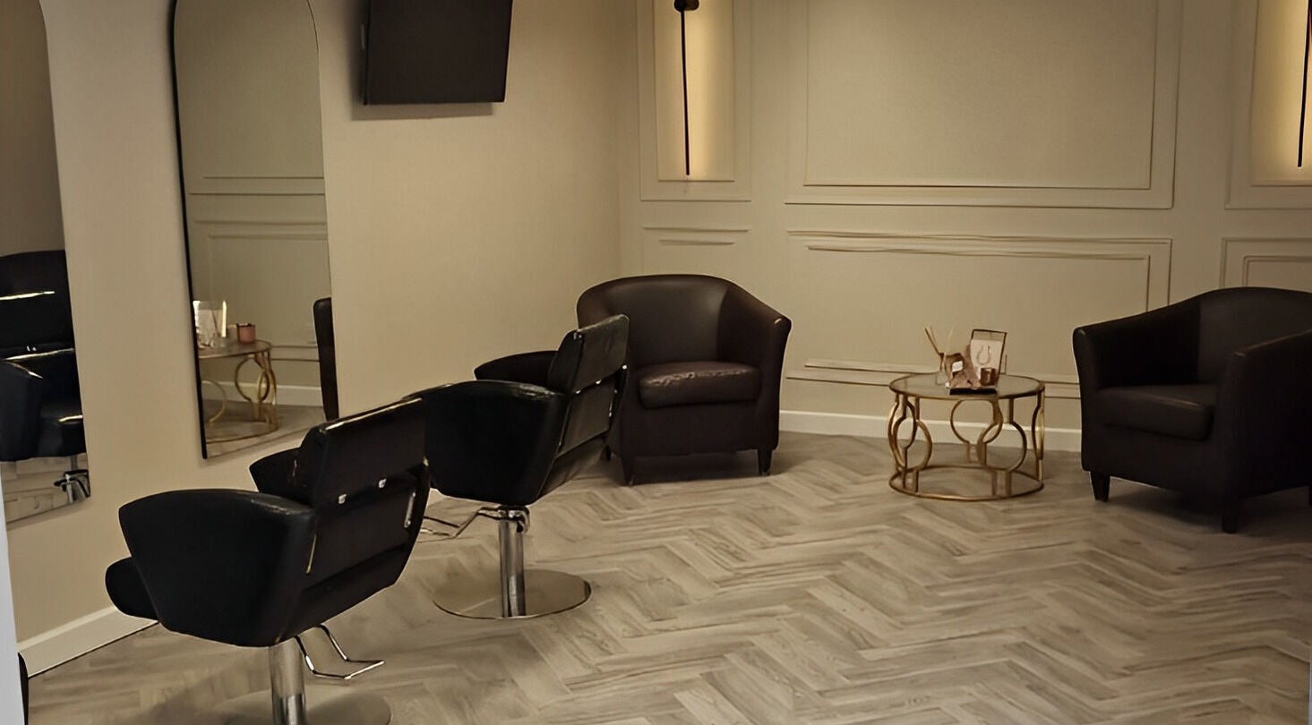 Modern salon seating at Omree Laser and Aesthetics, Stoke-on-Trent, England, GB; elegant chairs and coffee table.