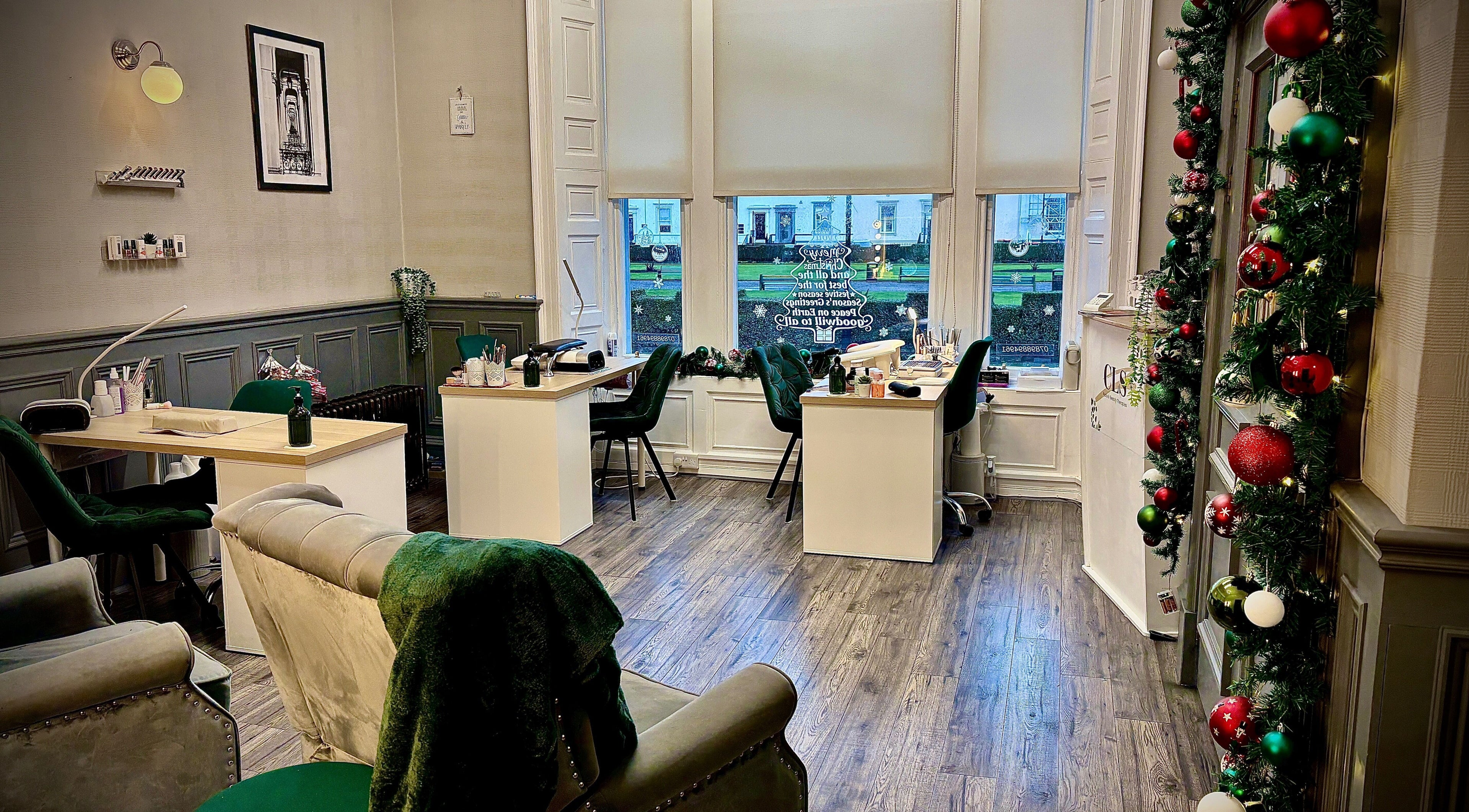 Elegant interior of Cls Nails & Beauty Therapies, Ayr, Scotland, GB, with holiday decor and cozy seating.