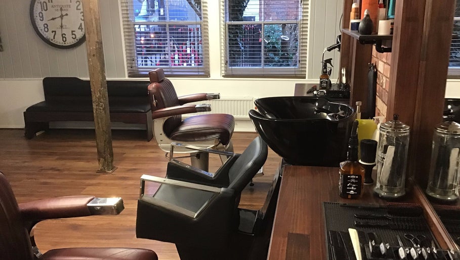 Barber chairs and grooming station at Rileys Barbers in Manningtree, England, GB, showcasing a vintage style.