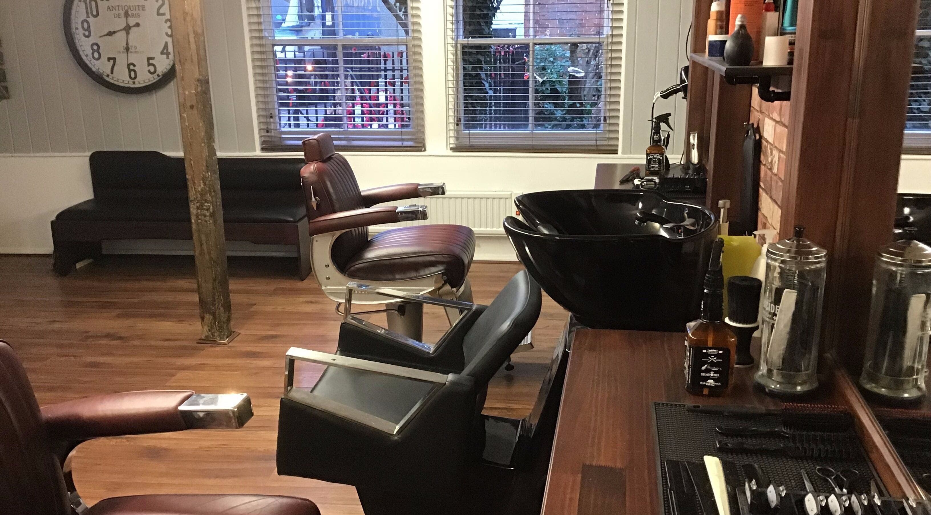 Barber chairs and grooming station at Rileys Barbers in Manningtree, England, GB, showcasing a vintage style.