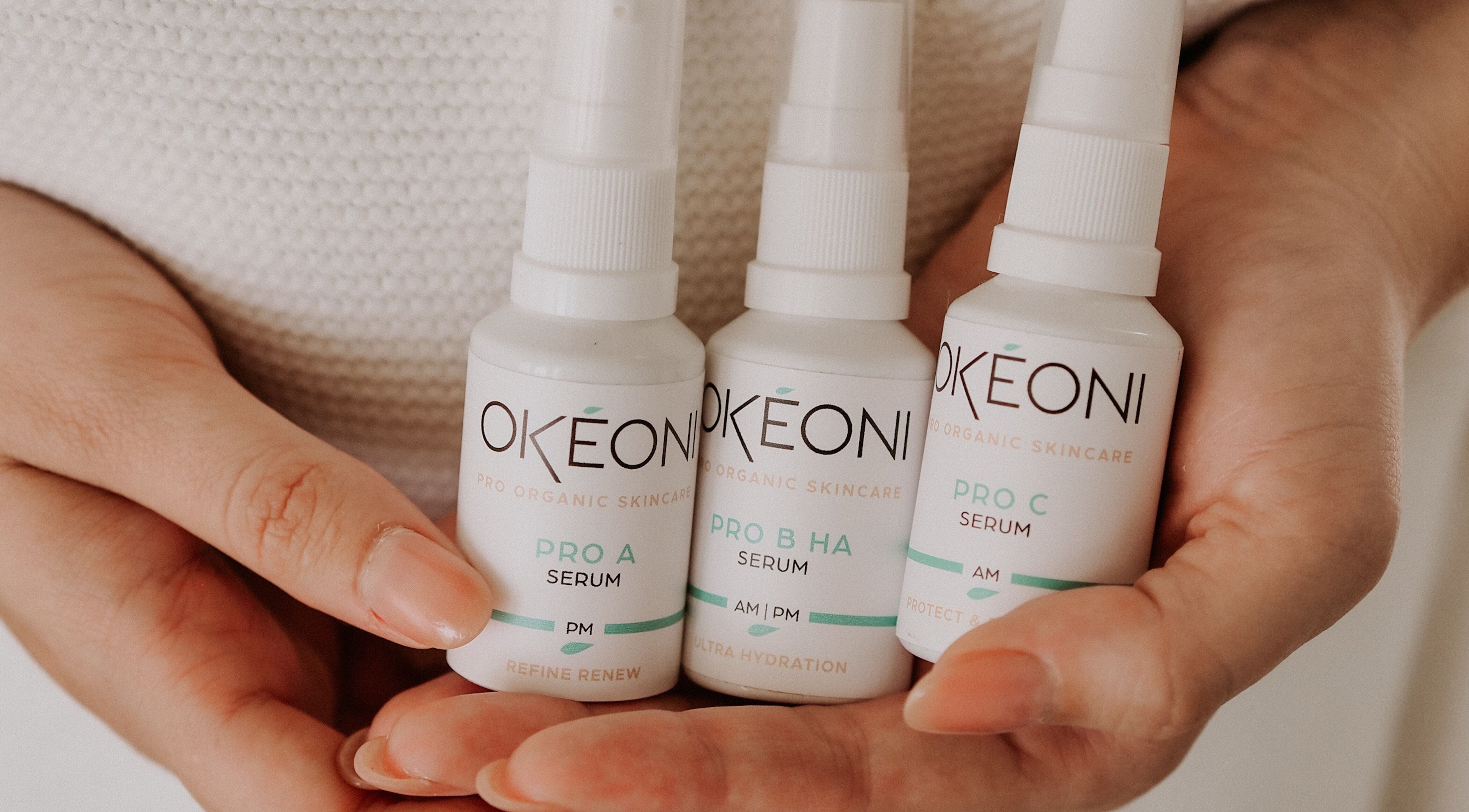 Hands holding skincare serums at SKINFUSIONS, Yeppoon, Queensland, AU.