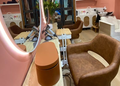 Elegant salon station at Rachel French Hairdresser, Sydney, New South Wales, AU, featuring leather chair and mirror.