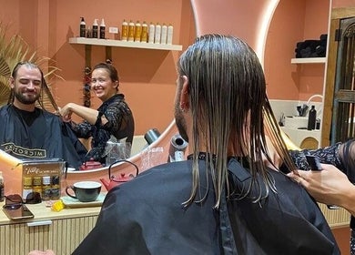 Stylist at Rachel French Hairdresser in Sydney, New South Wales, AU, expertly cutting a client's hair.