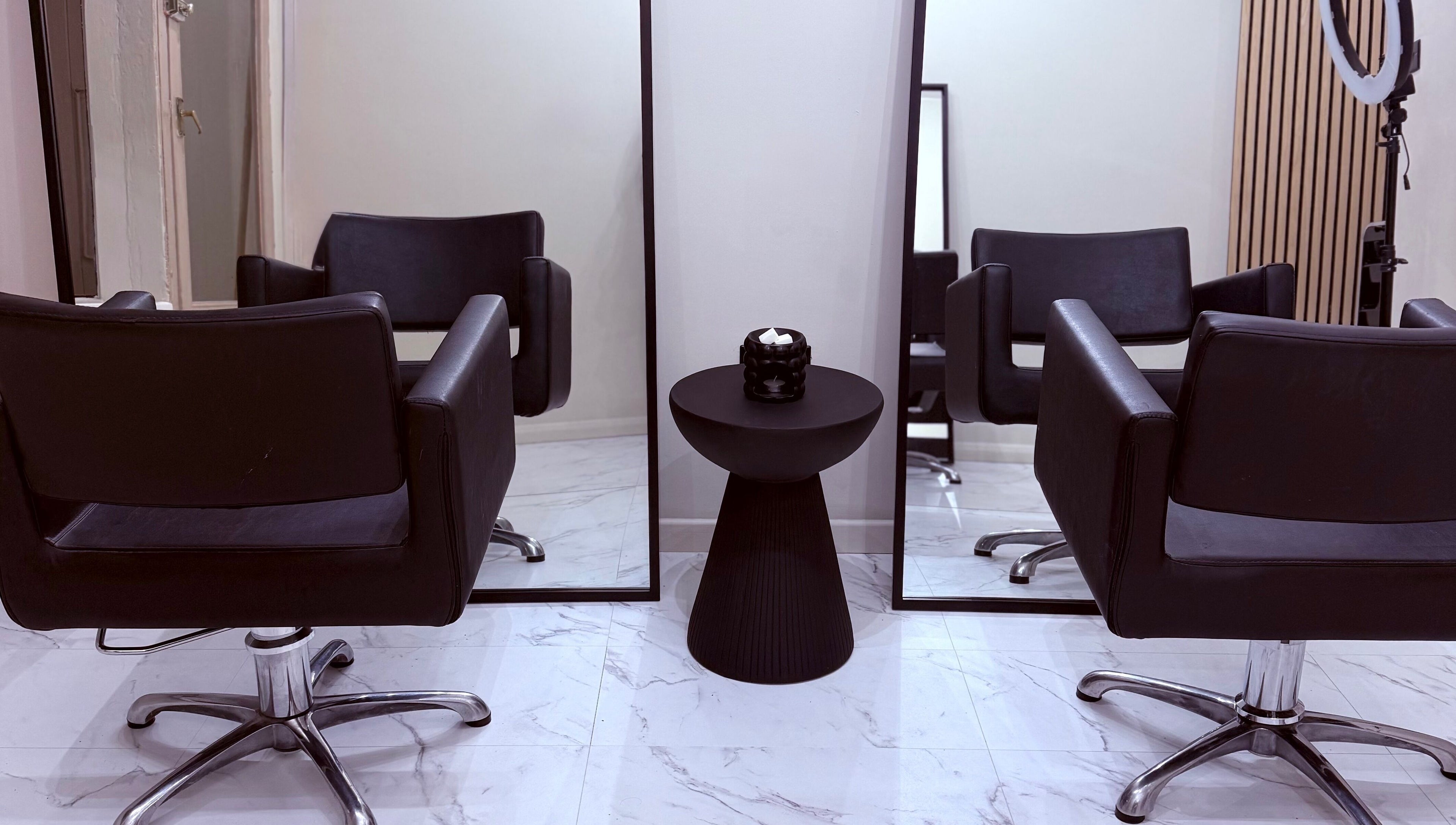 Modern salon chairs and mirrors at Socially Painted, Edinburgh, Scotland, GB, showcasing elegance.