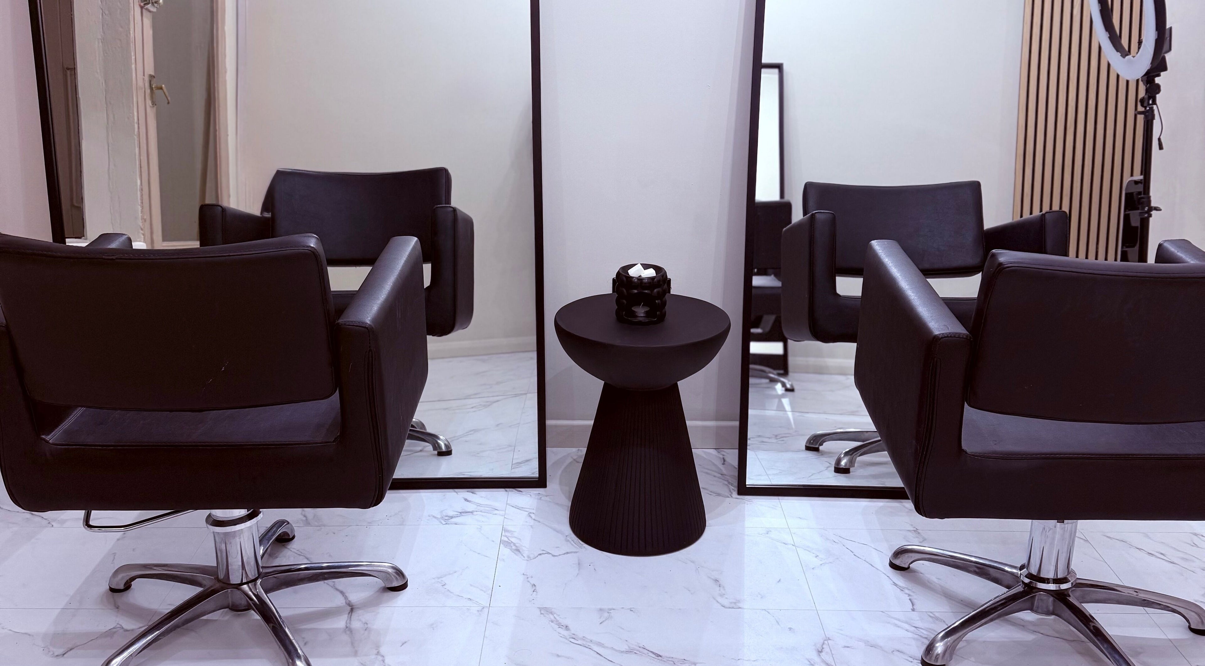 Modern salon chairs and mirrors at Socially Painted, Edinburgh, Scotland, GB, showcasing elegance.