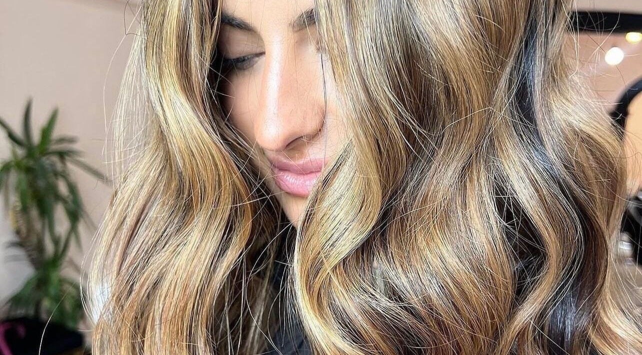 Glossy blonde hair styled at Socially Painted, Edinburgh, Scotland, GB. Perfect for vibrant beauty sessions.