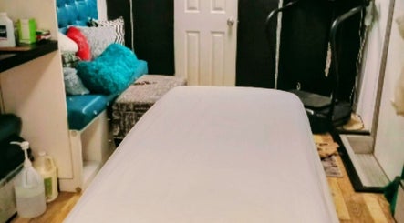 Relaxing treatment room at Motif Medi Spa, Nassau, New Providence, BS, featuring a massage bed and stylish decor.