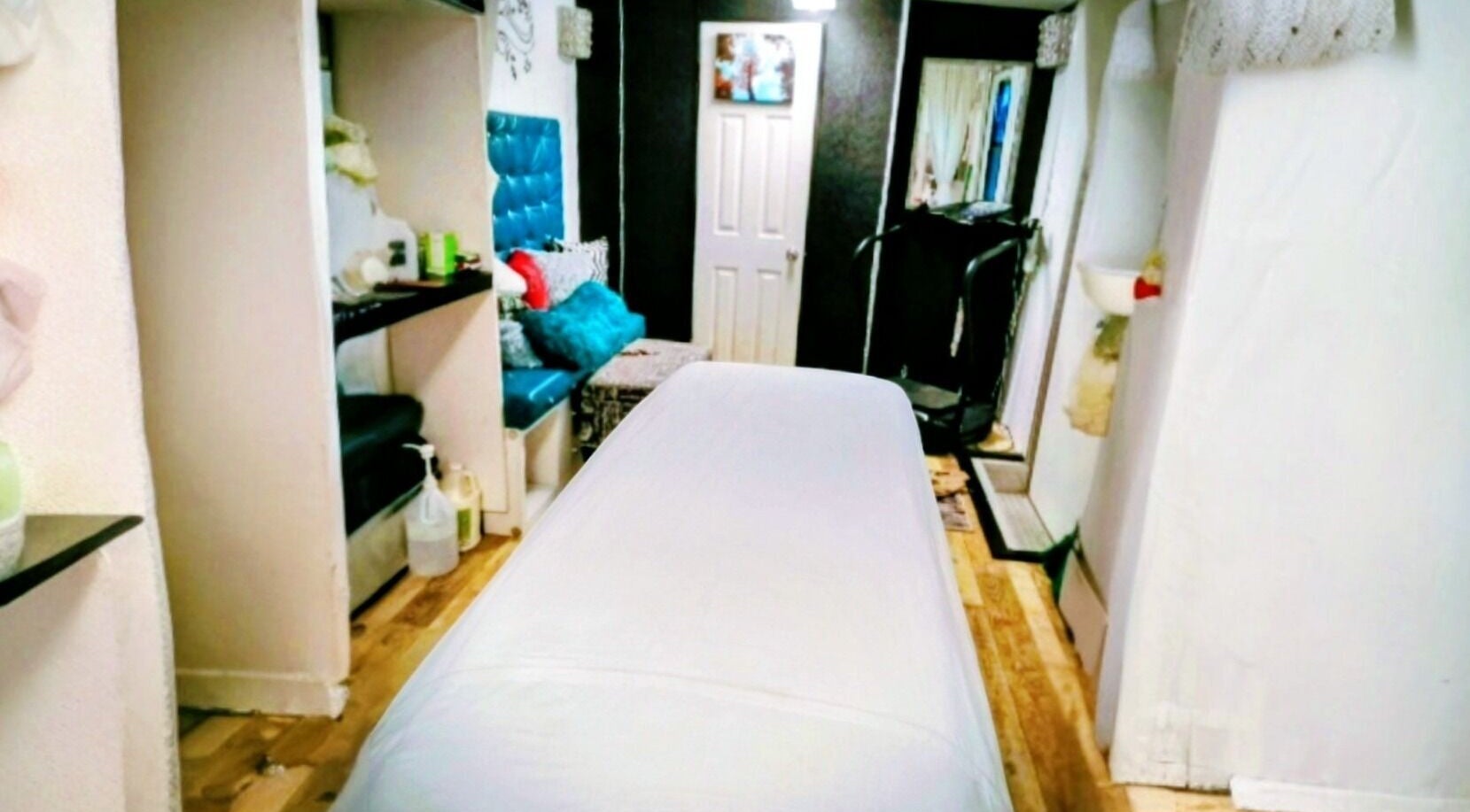 Relaxing treatment room at Motif Medi Spa, Nassau, New Providence, BS, with plush seating and calming decor.