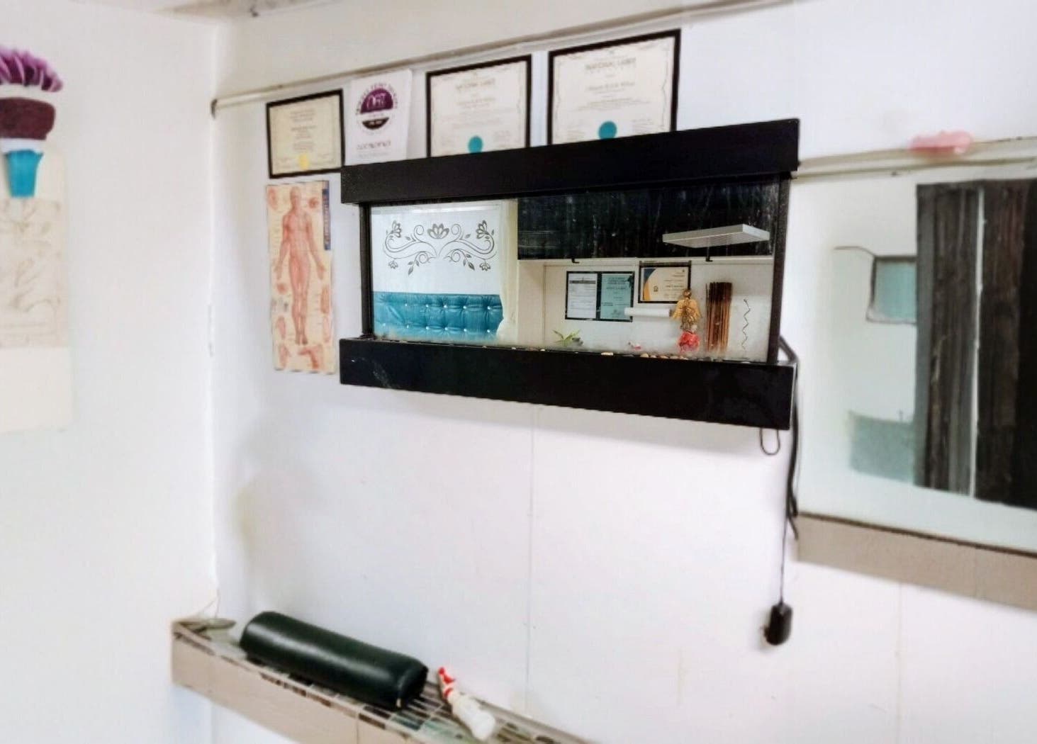 Wall at Motif Medi Spa, Nassau, New Providence, BS displaying certificates and decor.