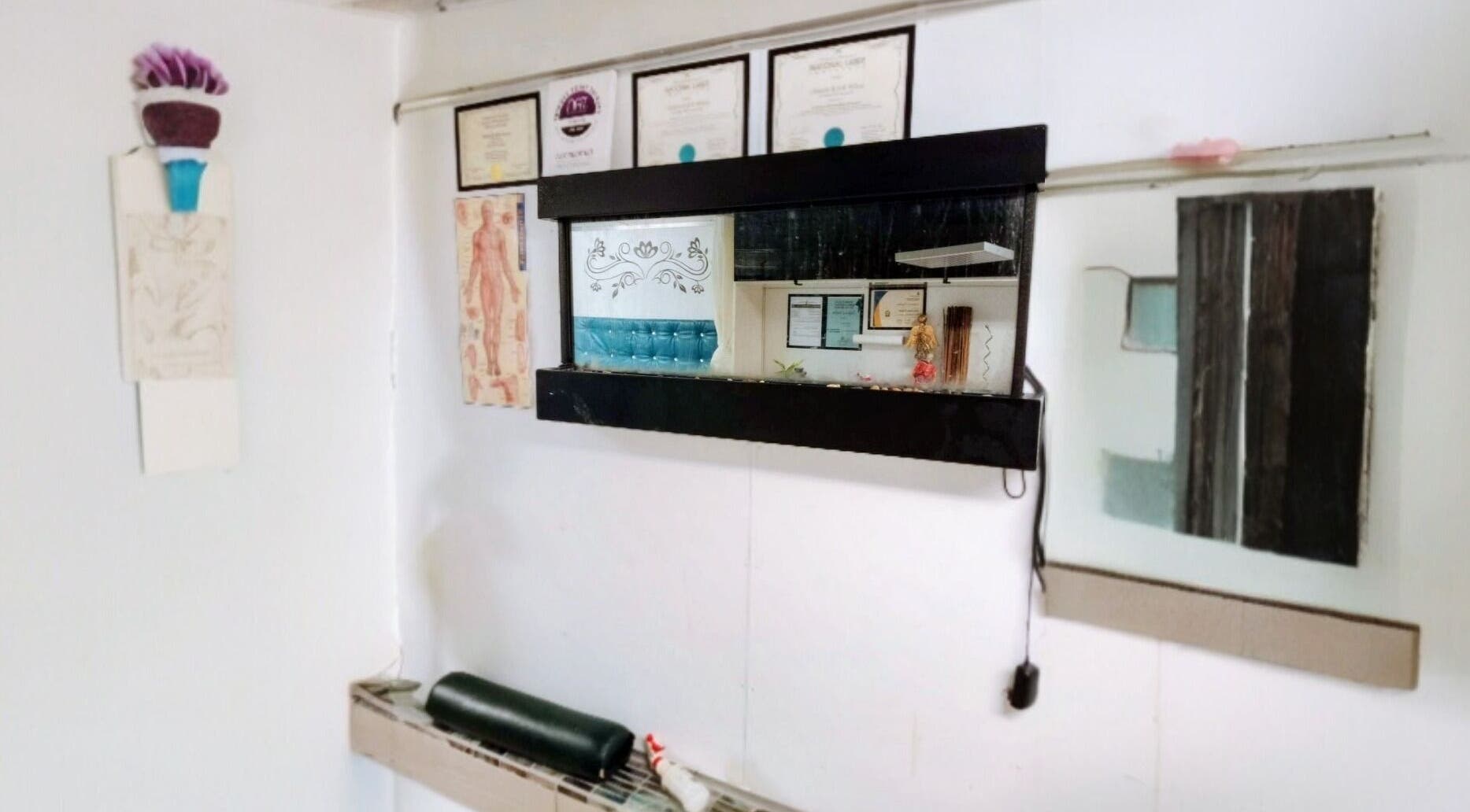 Wall at Motif Medi Spa, Nassau, New Providence, BS displaying certificates and decor.