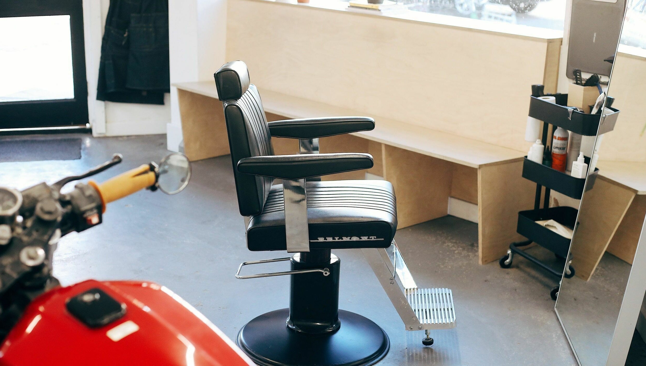 Stylish barber chair in Off Cut, Camberwell salon, London, England, GB, with a welcoming interior.