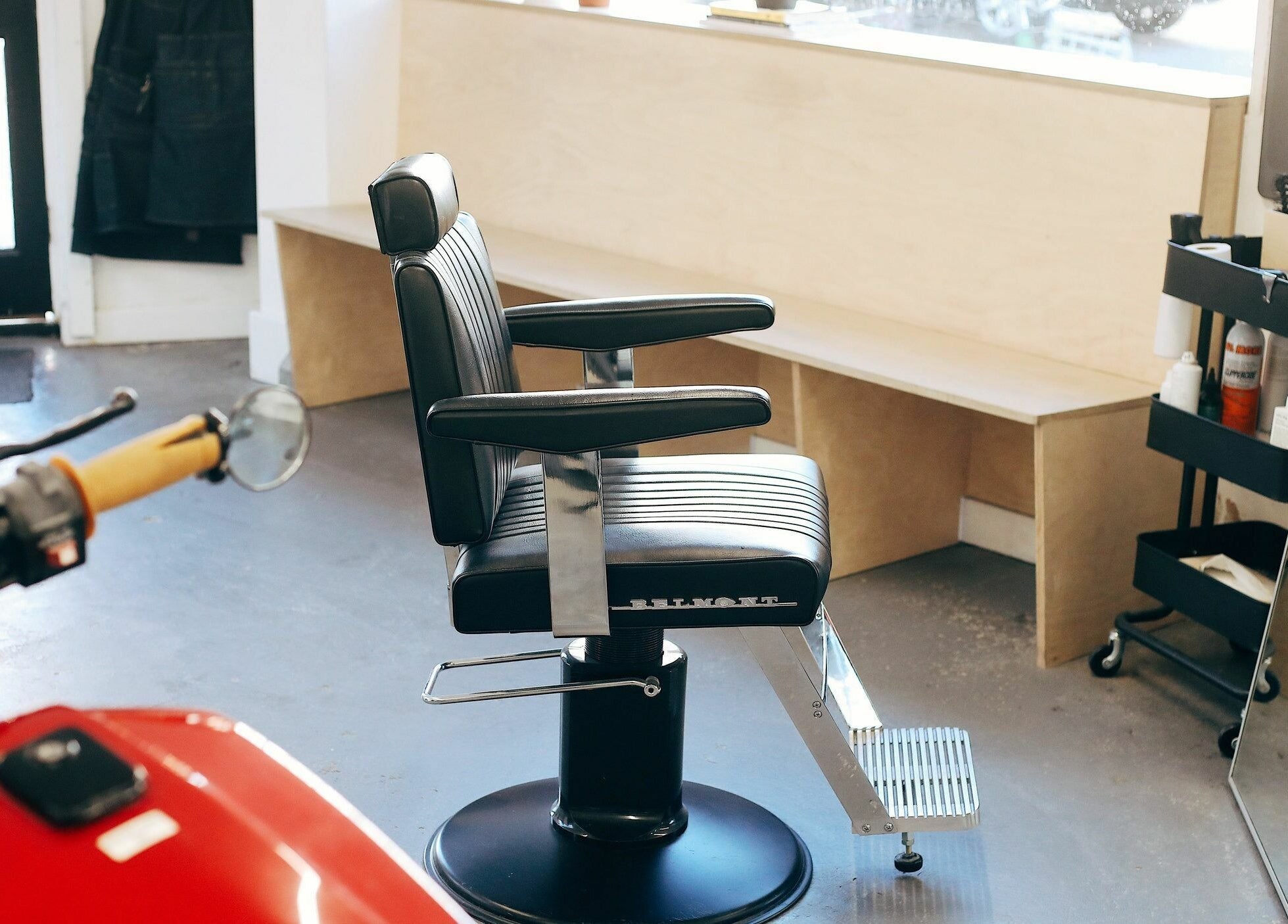 Stylish barber chair in Off Cut, Camberwell salon, London, England, GB, with a welcoming interior.