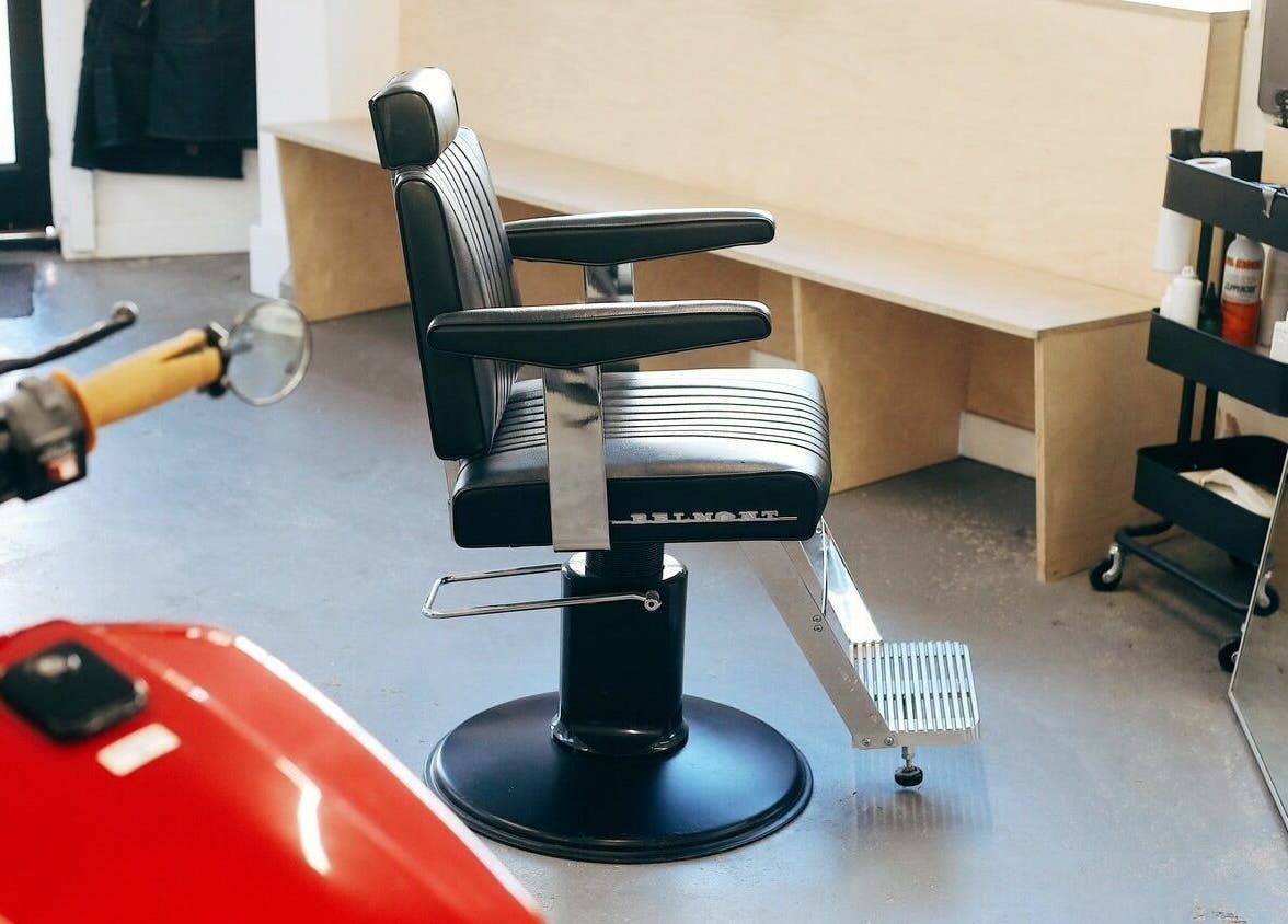 Modern barber chair at Off Cut, Crystal Palace in London, England, GB with sleek design and cozy seating.
