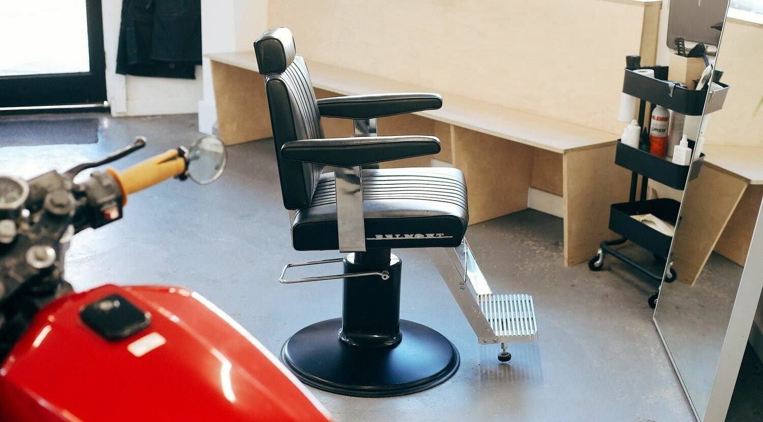 Modern barber chair at Off Cut, Crystal Palace in London, England, GB with sleek design and cozy seating.