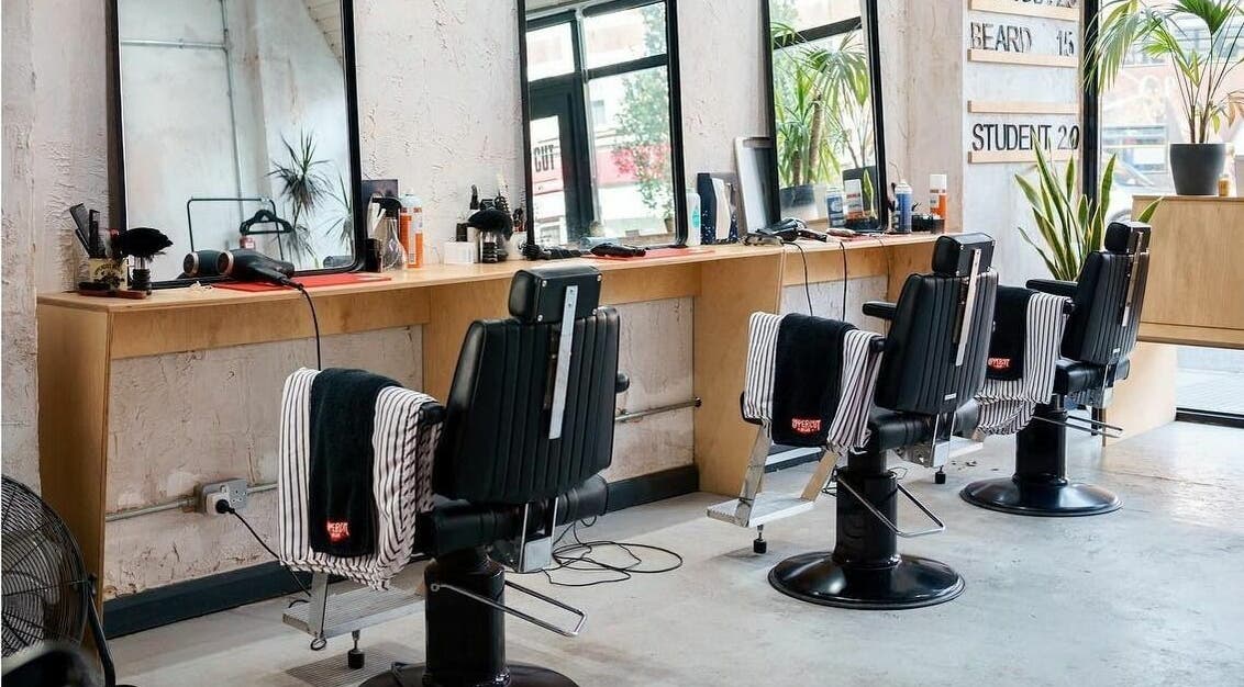 Modern barber chairs and mirrors at Off Cut, Peckham in London, England, GB showcasing a sleek interior.