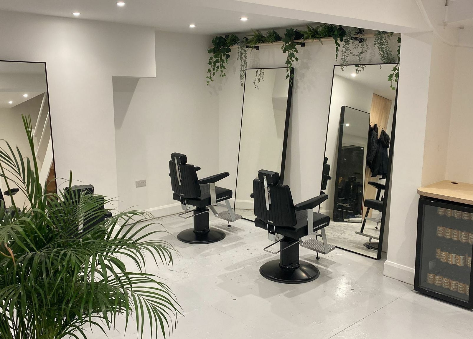 Modern salon chairs and lush plants at Off Cut, Peckham, London, England, GB.