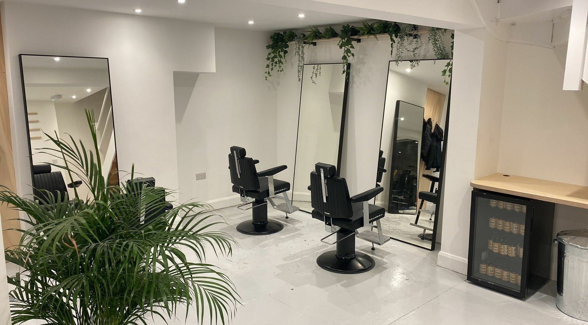 Modern salon chairs and lush plants at Off Cut, Peckham, London, England, GB.