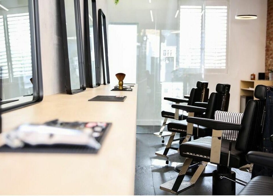 Modern barber chairs at Off Cut, Peckham in London, England, GB highlighting sleek design.