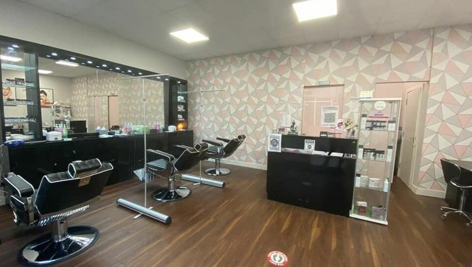Modern interior of Ami Brow and Lash Bar in Rugby, England, GB, featuring stylish salon chairs and geometric decor.