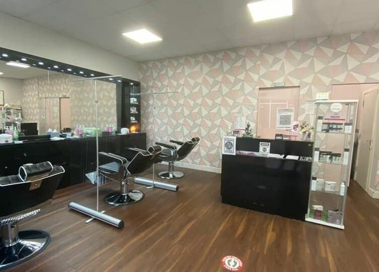 Modern interior of Ami Brow and Lash Bar in Rugby, England, GB, featuring stylish salon chairs and geometric decor.