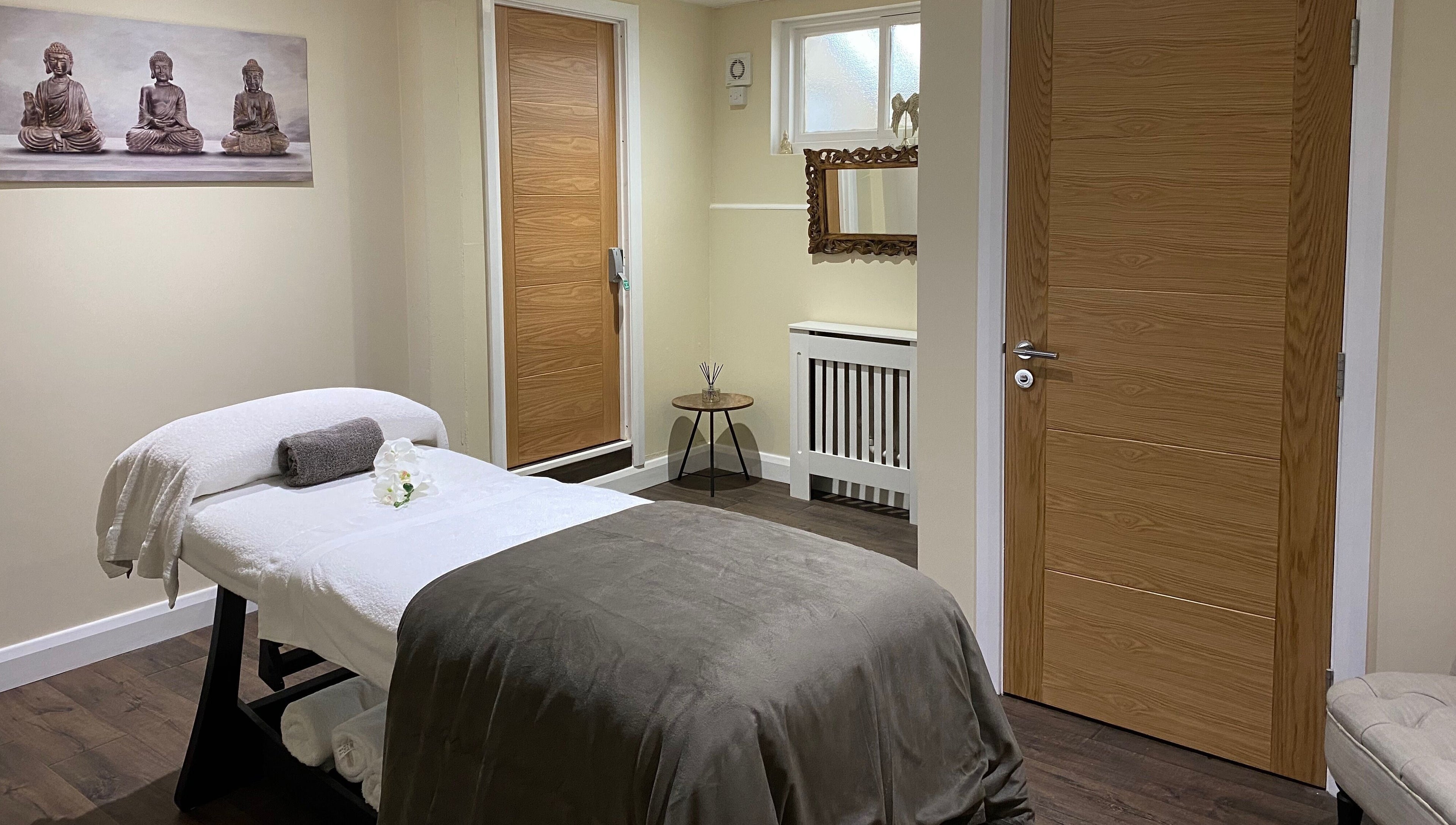 Relaxing massage room at Natural Body Cafe, Poole, England, GB with spa bed and calming décor.