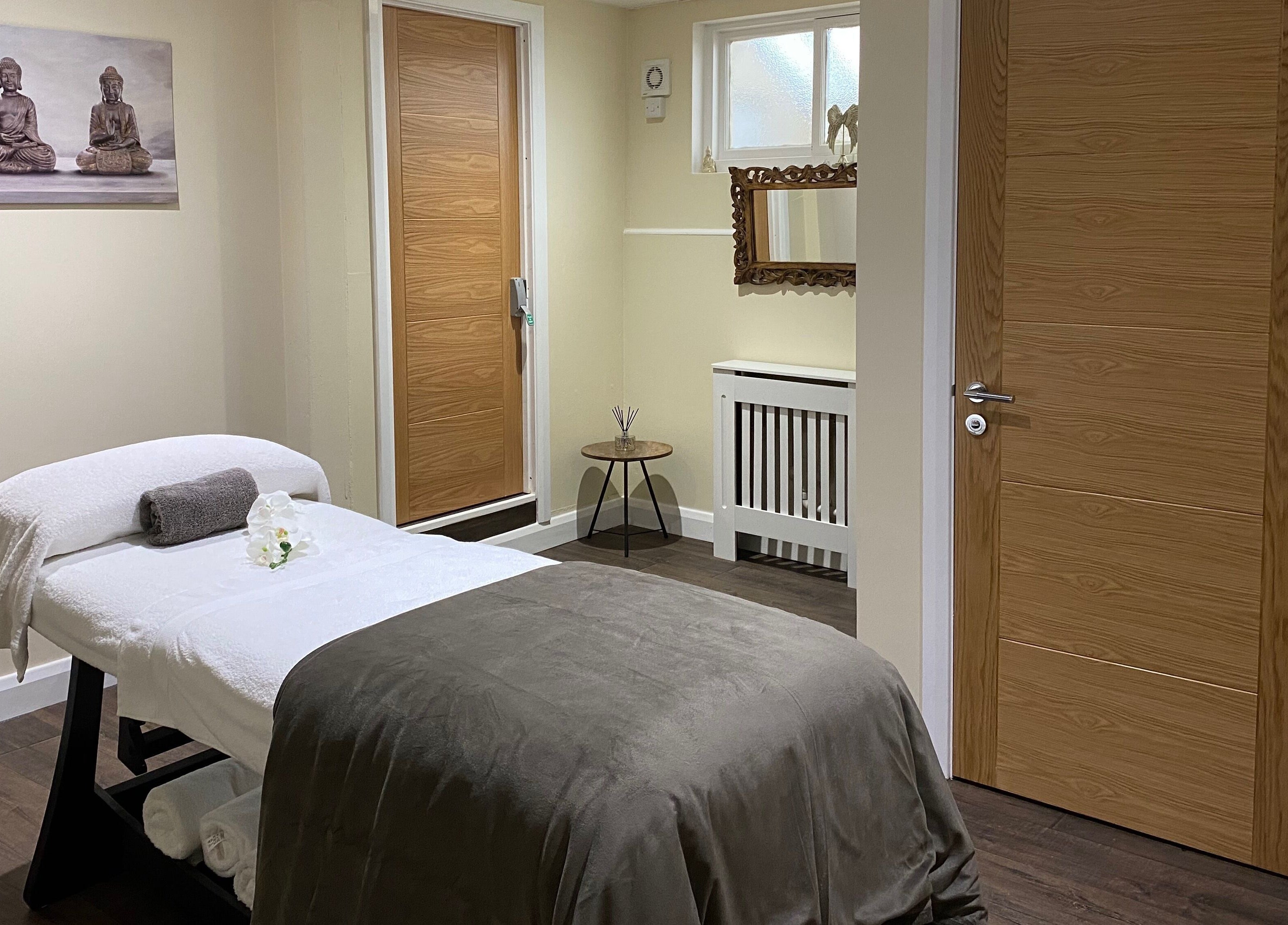 Relaxing massage room at Natural Body Cafe, Poole, England, GB with spa bed and calming décor.