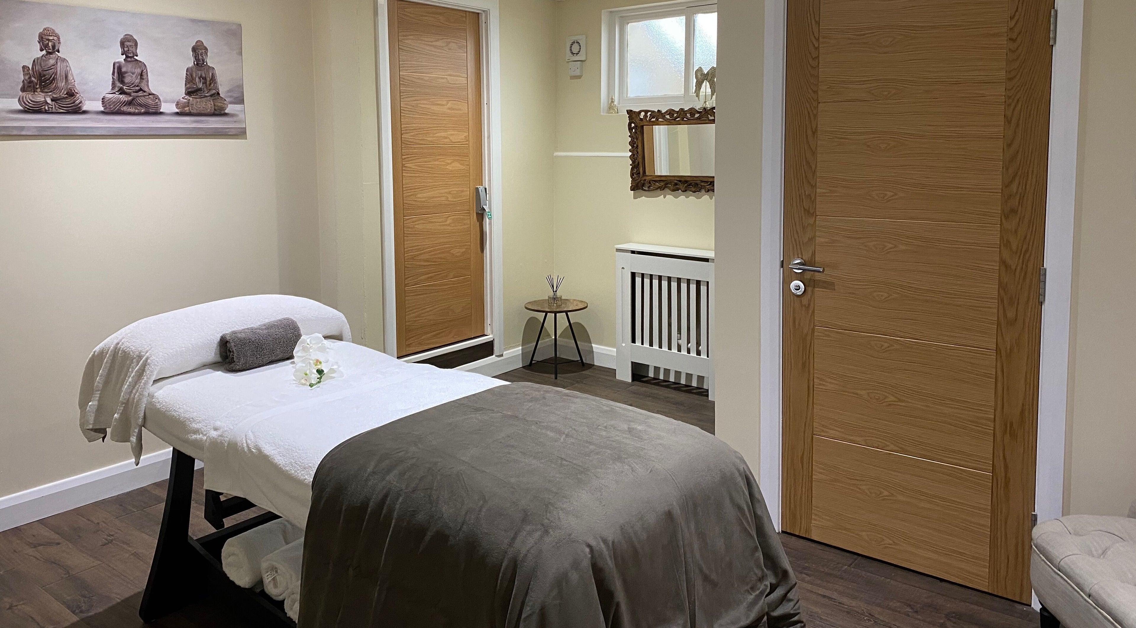 Relaxing massage room at Natural Body Cafe, Poole, England, GB with spa bed and calming décor.