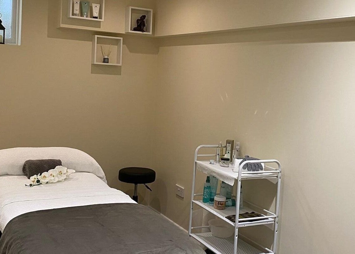 Calm treatment room at Natural Body Cafe, Poole, England, GB with spa bed and soft lighting.