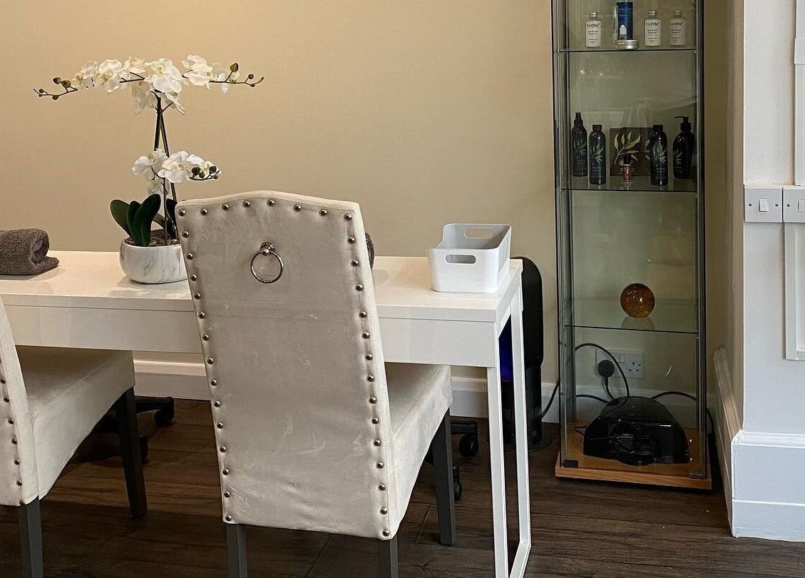 Elegant spa treatment area at Natural Body Cafe, Poole, England, GB with plush chairs and decorative plants.