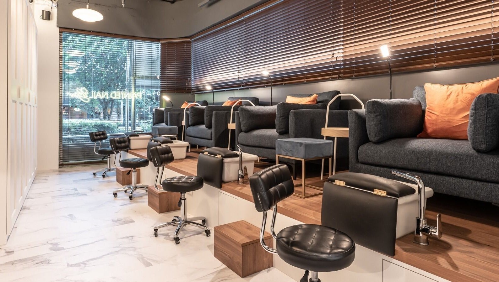 Elegant interior of Painted Nail Bar at Delfi Orchard, Orchard Road, Singapore, SG with plush seating and modern décor.