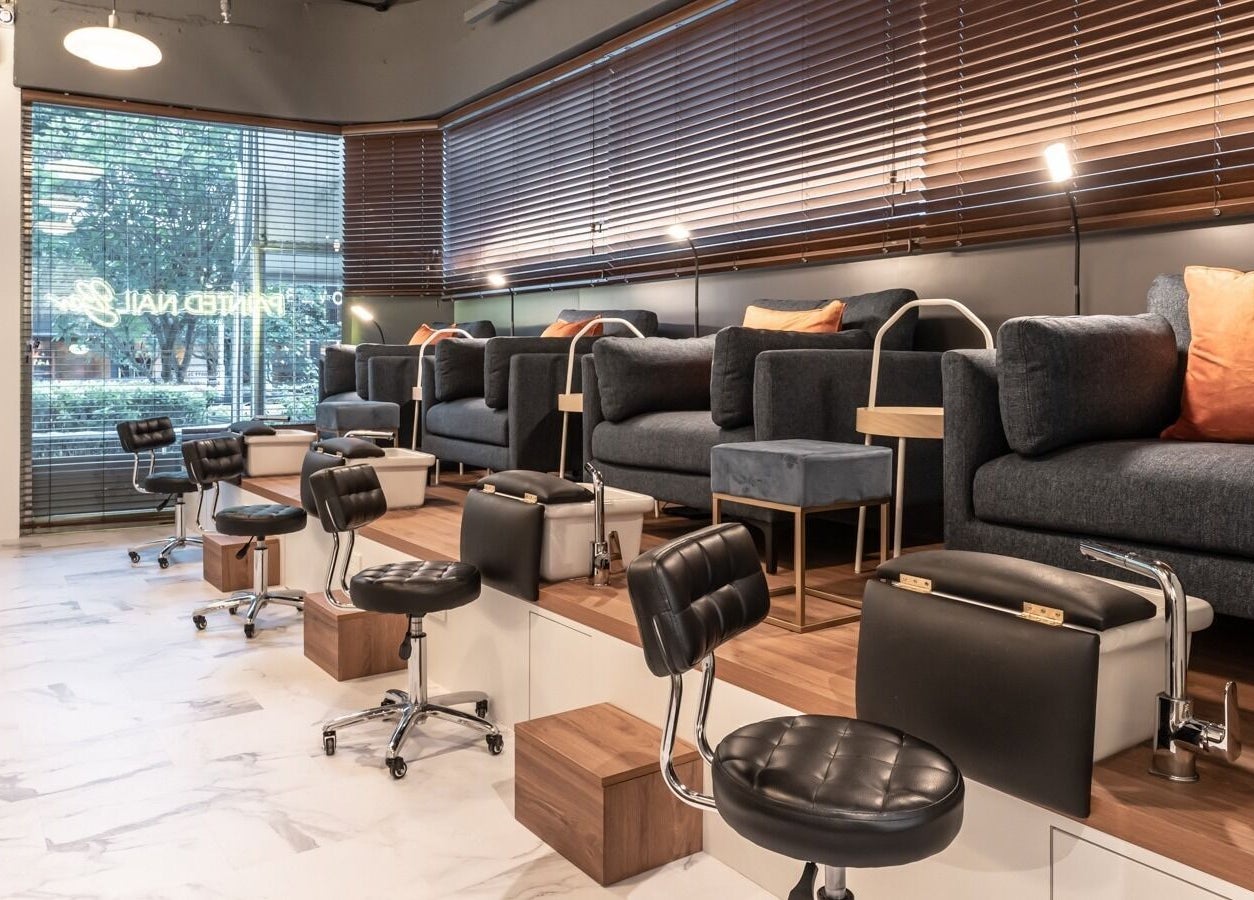 Elegant interior of Painted Nail Bar at Delfi Orchard, Orchard Road, Singapore, SG with plush seating and modern décor.