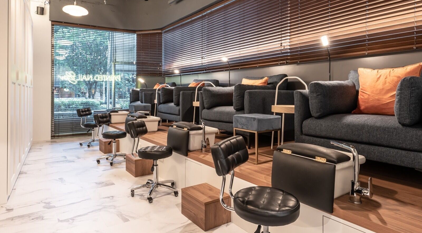 Elegant interior of Painted Nail Bar at Delfi Orchard, Orchard Road, Singapore, SG with plush seating and modern décor.