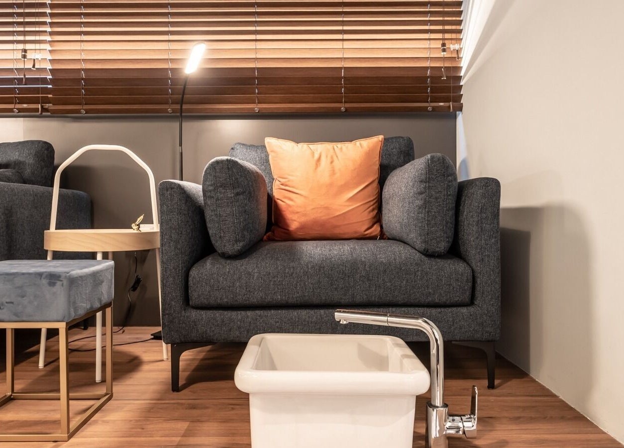 Pedicure setup at Painted Nail Bar at Delfi Orchard, Orchard Road, Singapore, SG with plush seating and sink.