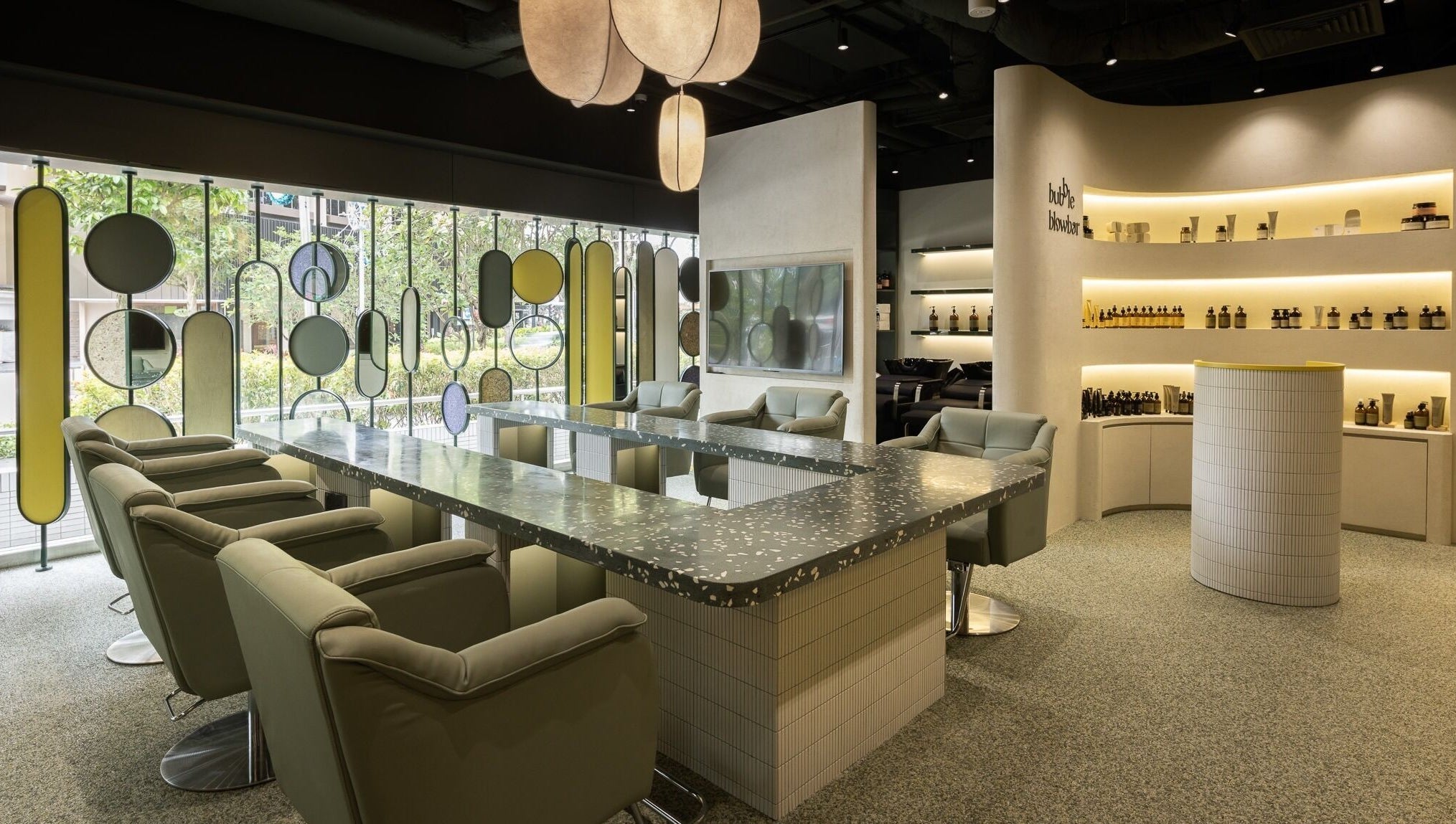 Modern interior of Bubble Blow Bar at Delfi Orchard, Singapore, SG with stylish chairs and decor.