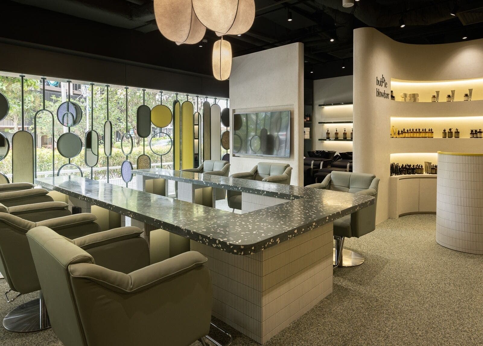 Modern interior of Bubble Blow Bar at Delfi Orchard, Singapore, SG with stylish chairs and decor.