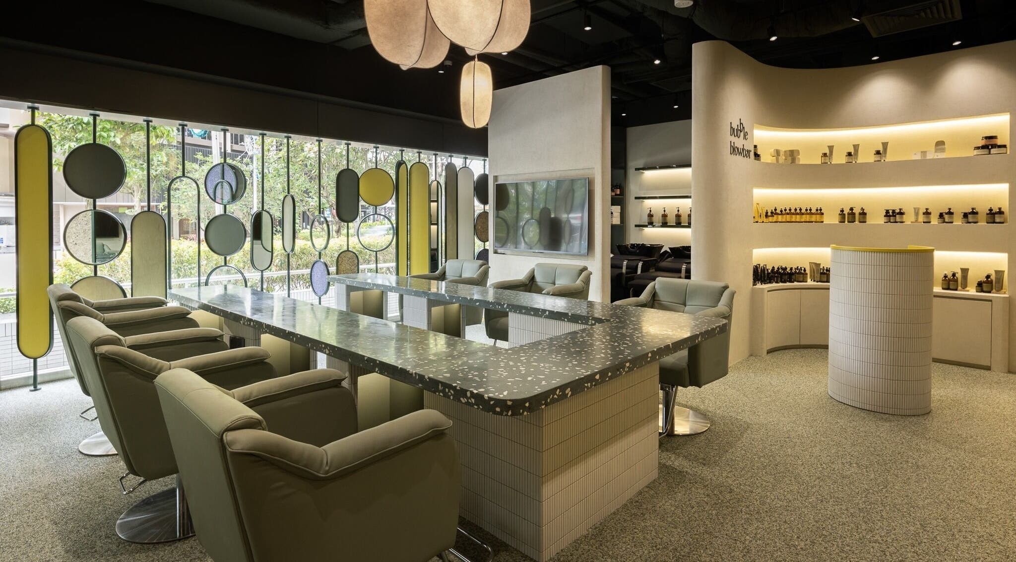 Modern interior of Bubble Blow Bar at Delfi Orchard, Singapore, SG with stylish chairs and decor.