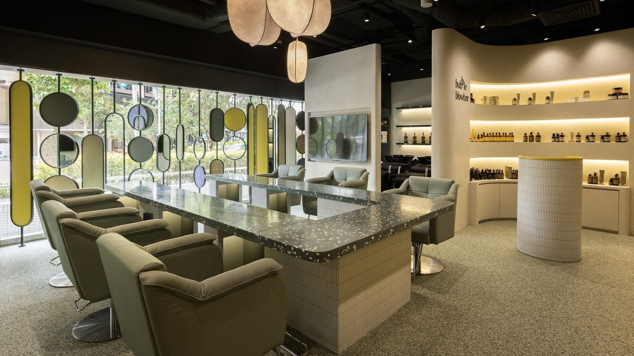Modern interior of Bubble Blow Bar at Delfi Orchard, Singapore, SG with stylish chairs and decor.