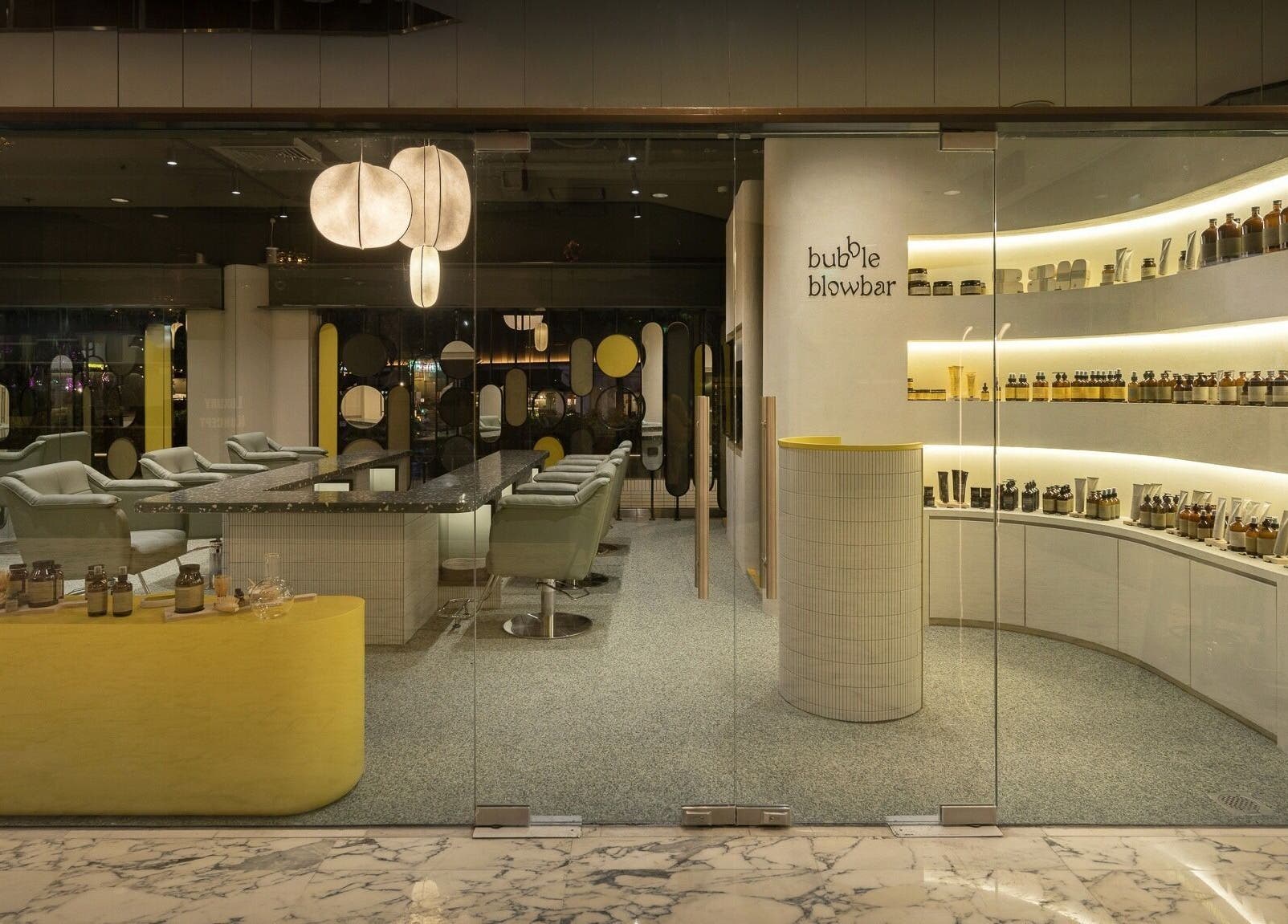 Interior of Bubble Blow Bar at Delfi Orchard, Singapore, showcasing elegant decor and beauty products.