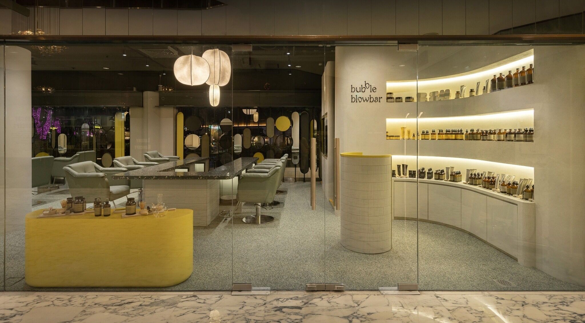 Interior of Bubble Blow Bar at Delfi Orchard, Singapore, showcasing elegant decor and beauty products.