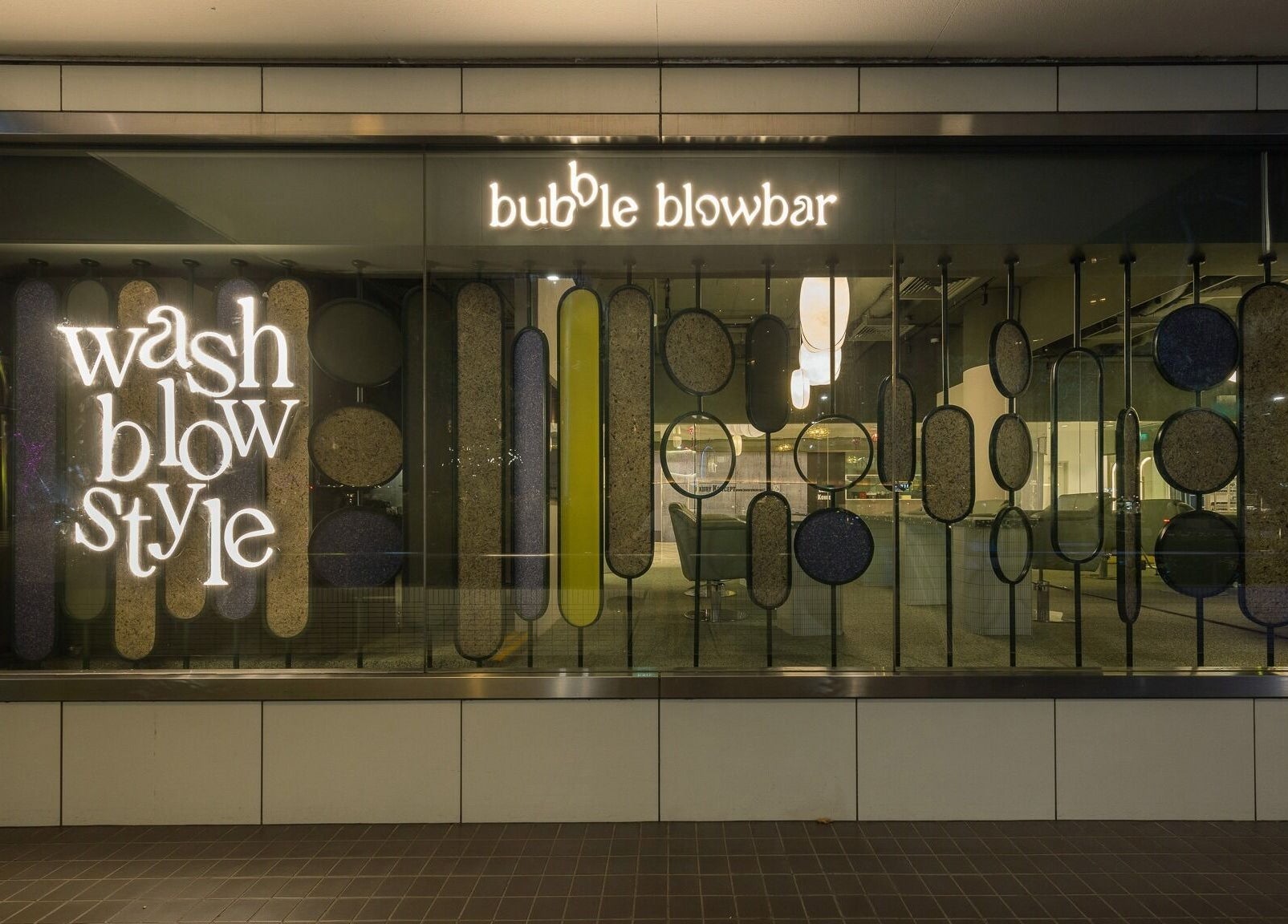 Illuminated facade of Bubble Blow Bar at Delfi Orchard, Singapore, SG with stylish signage.