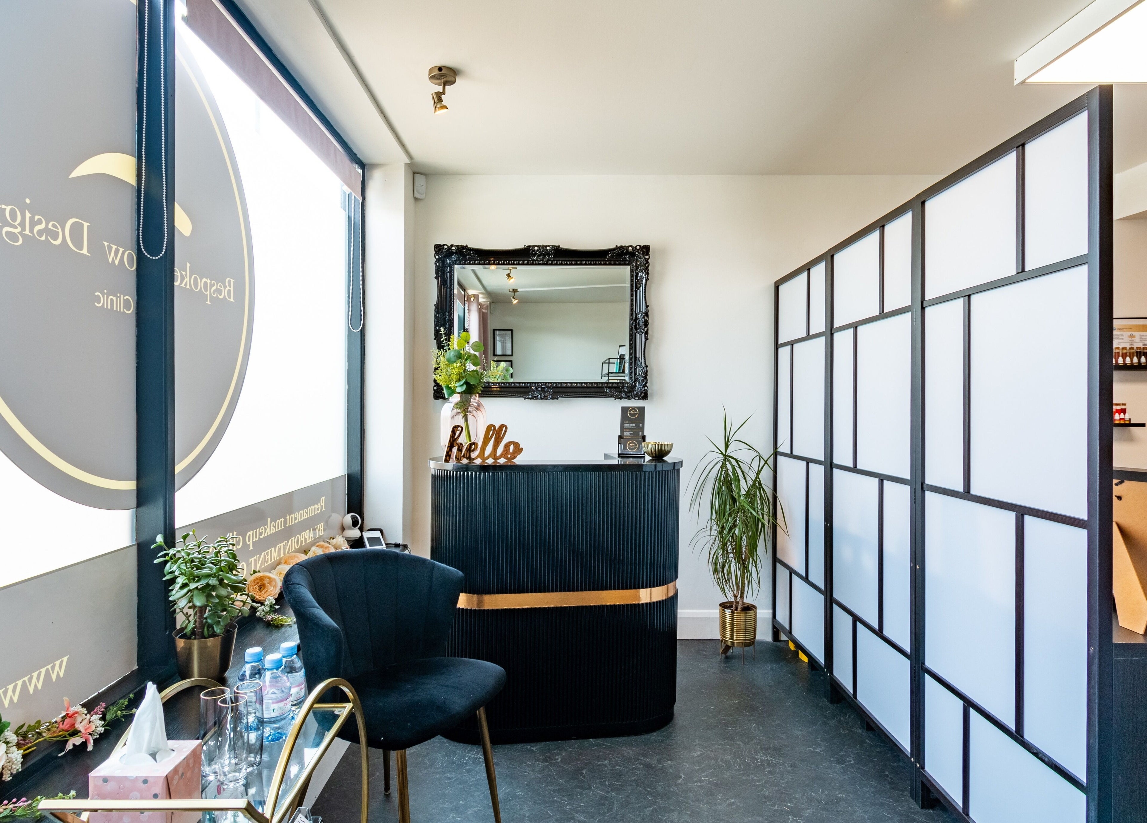 Modern reception area at Bespoke Brow Design in Rustington, England, GB with stylish decor and black furniture.