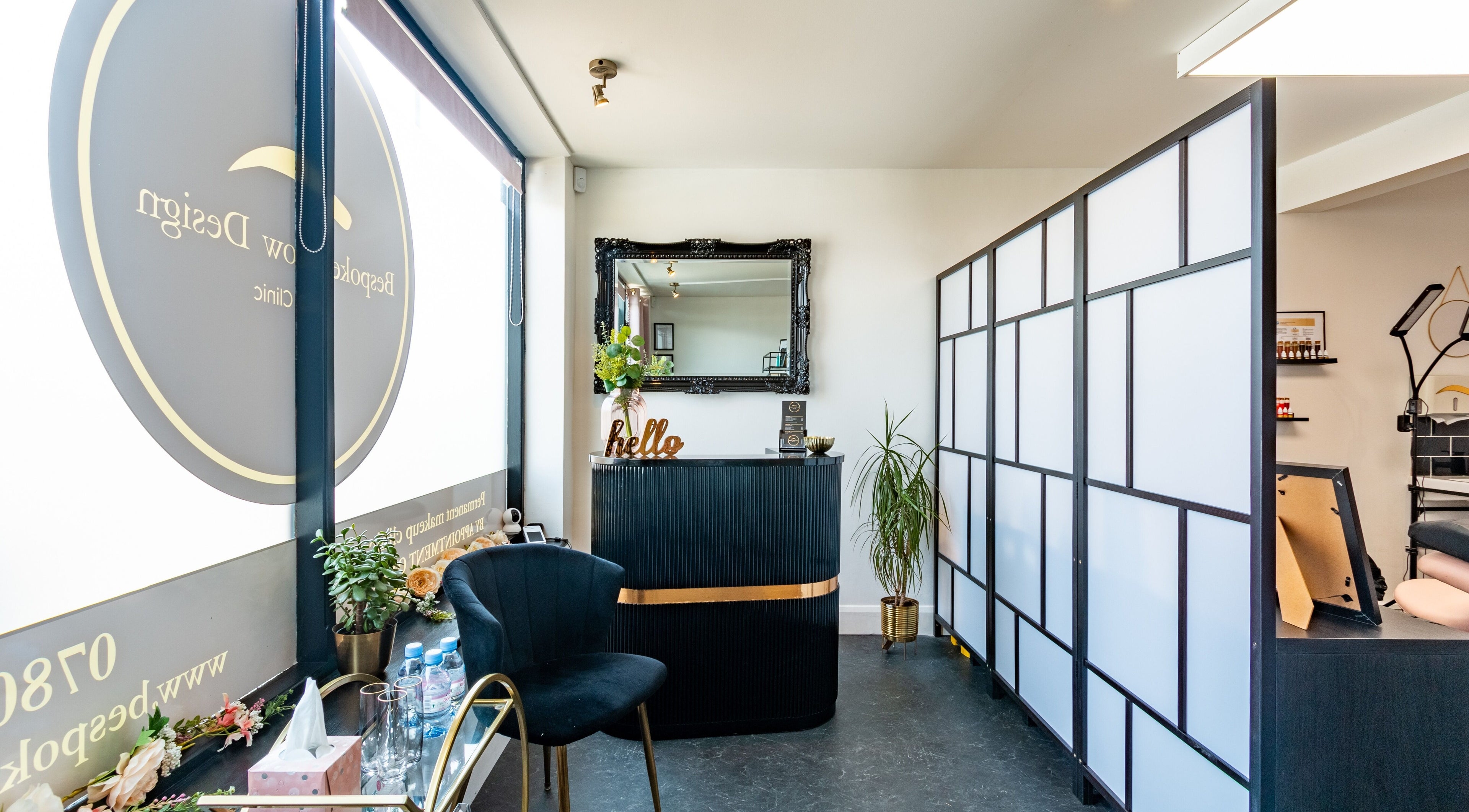 Modern reception area at Bespoke Brow Design in Rustington, England, GB with stylish decor and black furniture.