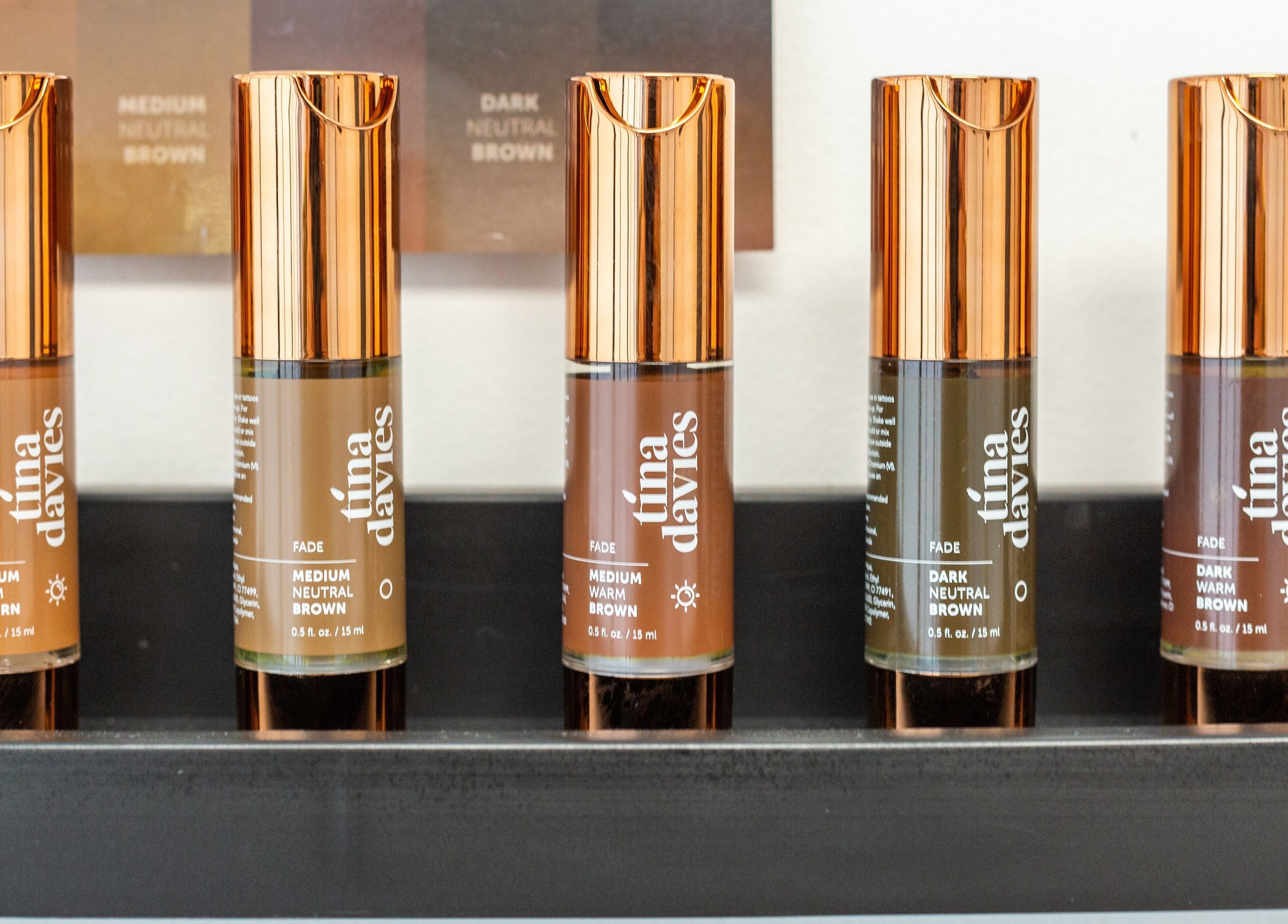 Bespoke Brow Design in Rustington, England, displays premium brow pigments on a sleek shelf.