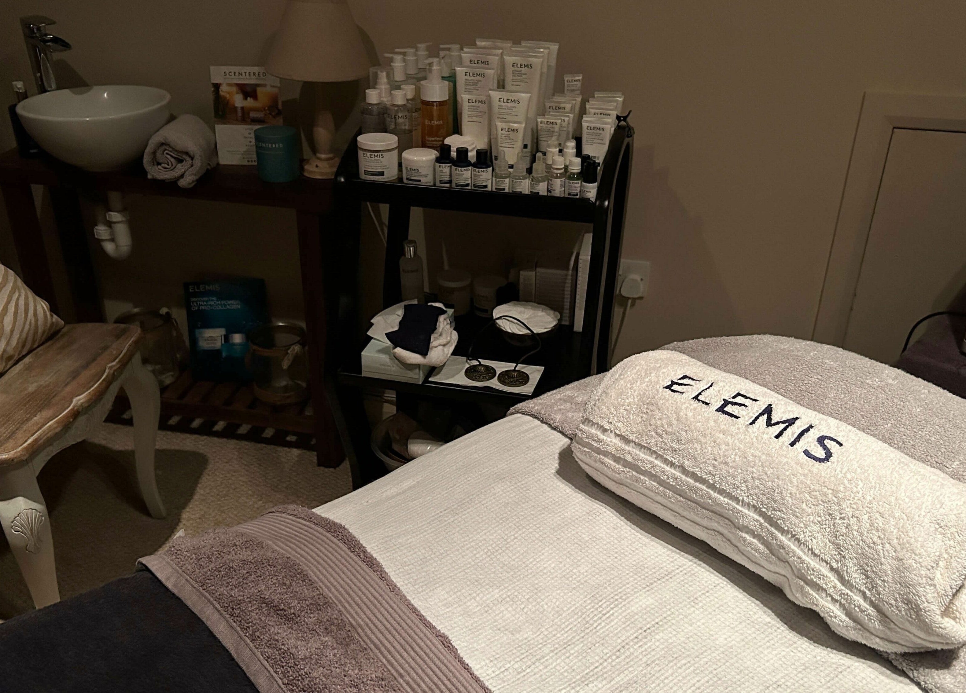 Tranquil treatment room at Pure Indulgence Day Spa, Merton, England, GB with Elemis products on display.