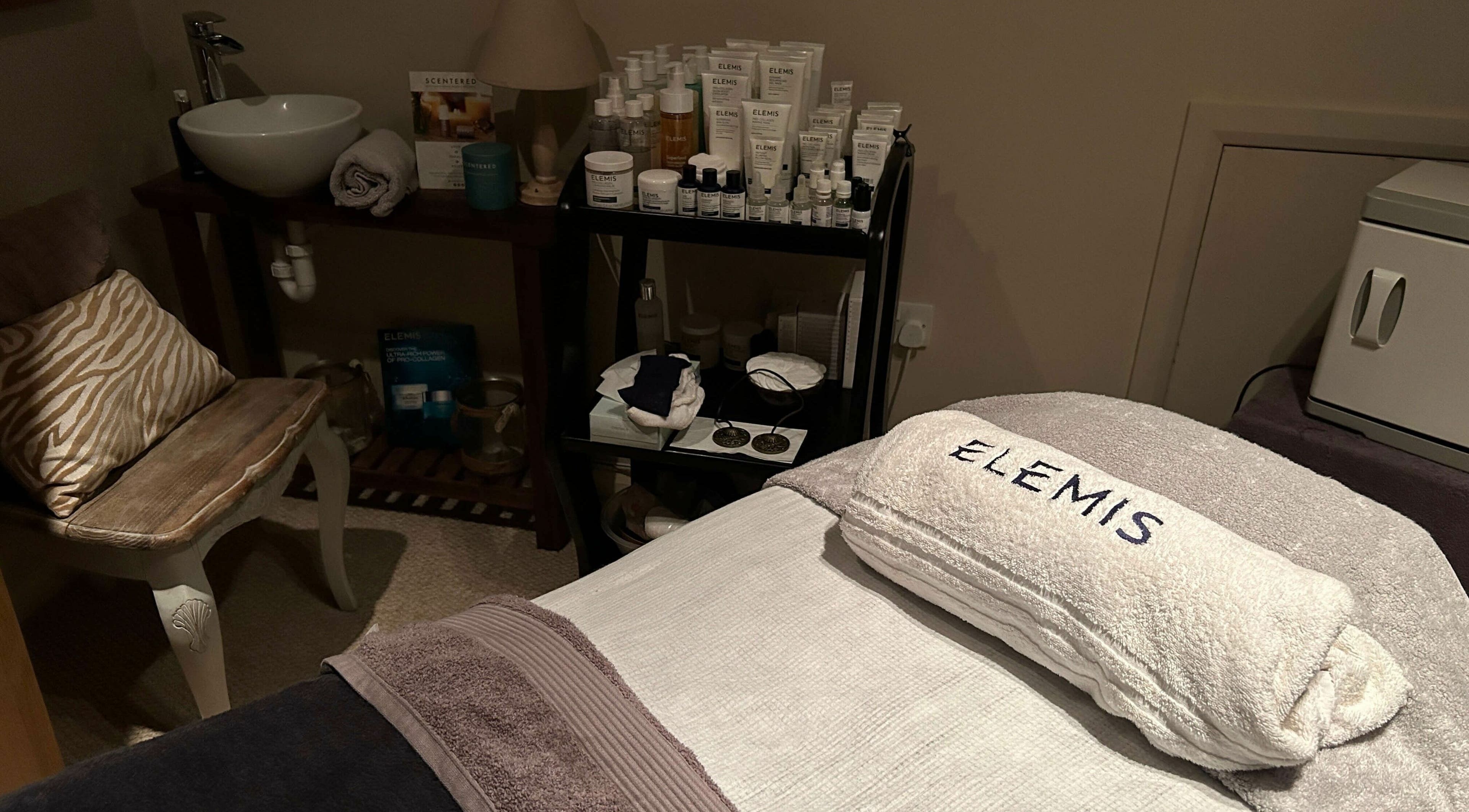 Tranquil treatment room at Pure Indulgence Day Spa, Merton, England, GB with Elemis products on display.