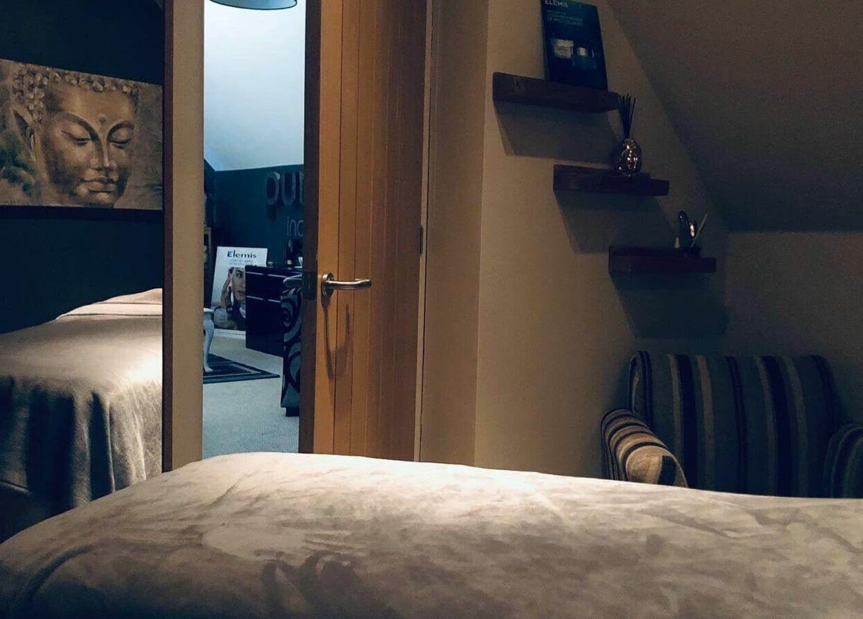 Cozy treatment room at Pure Indulgence Day Spa in Merton, England, GB with calming Buddha artwork.