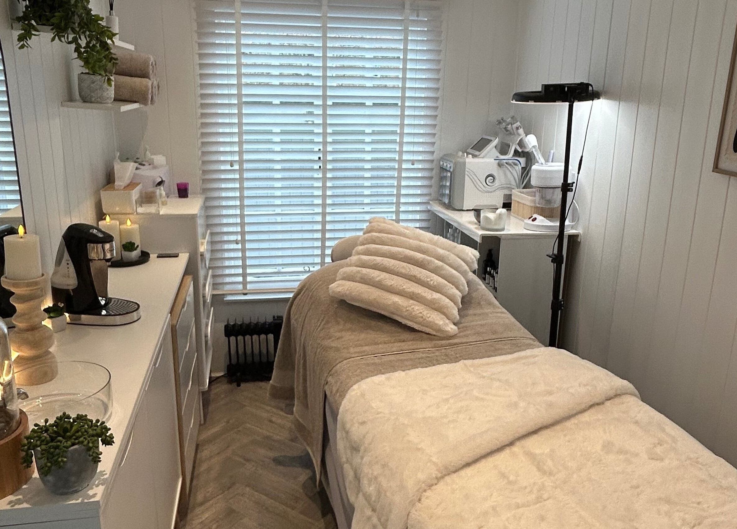 Relaxing treatment room at The Beauty Hut in Wivelsfield Green, England, GB, featuring a serene setup.