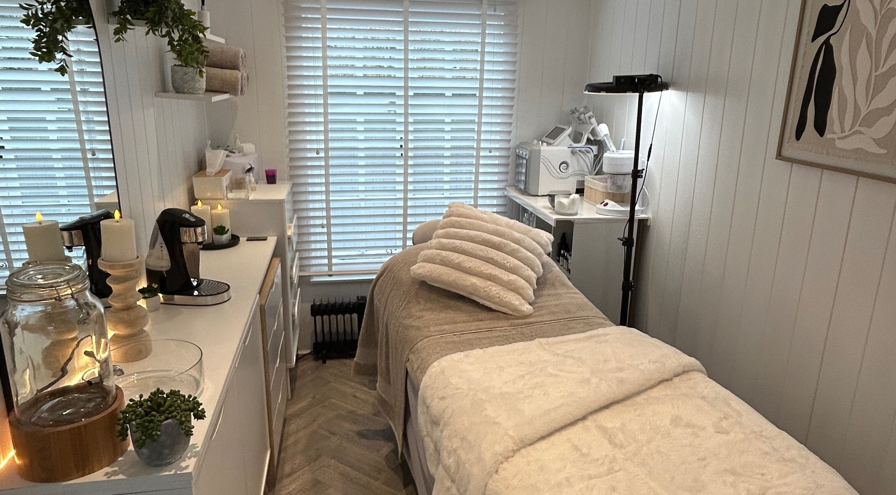 Relaxing treatment room at The Beauty Hut in Wivelsfield Green, England, GB, featuring a serene setup.