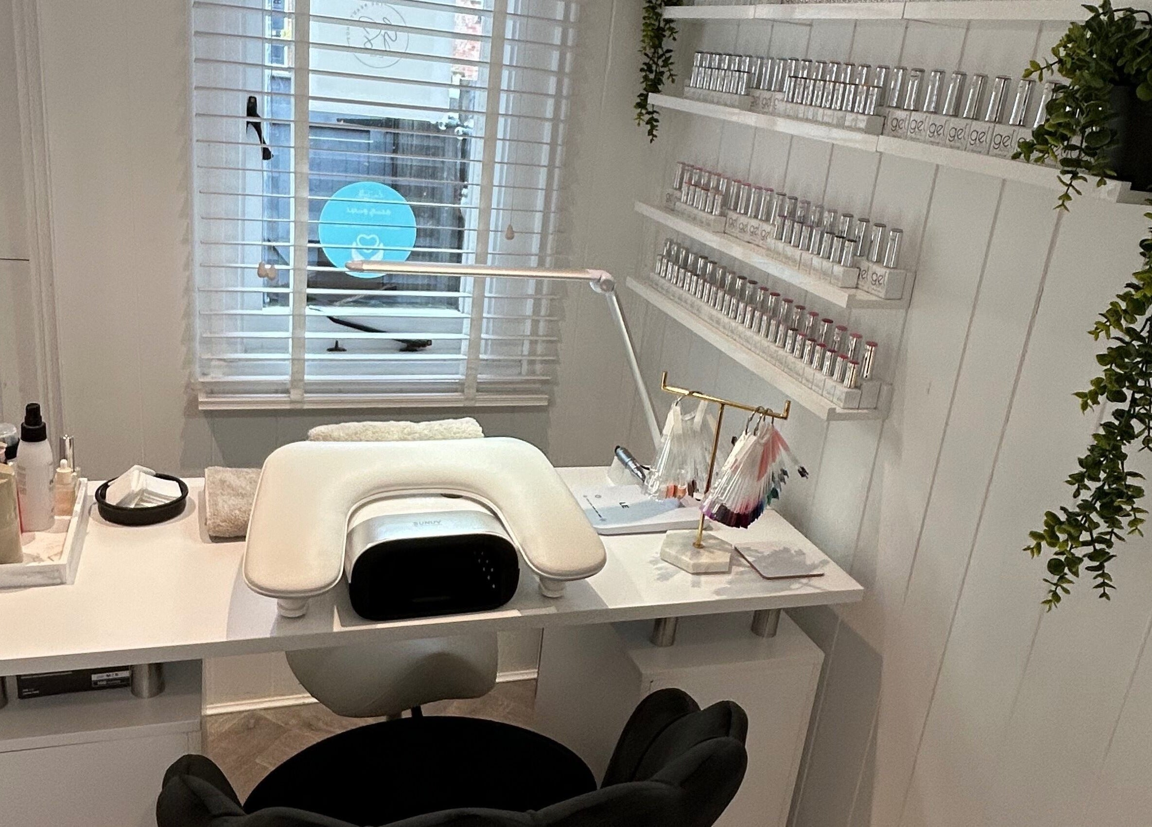 Elegant manicure station at The Beauty Hut, Wivelsfield Green, England with nail polish display and tools.