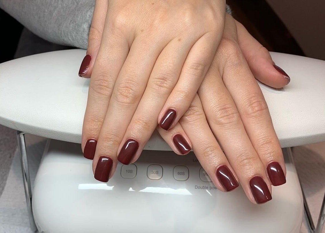 Elegant burgundy manicure at The Beauty Hut in Wivelsfield Green, England, GB.